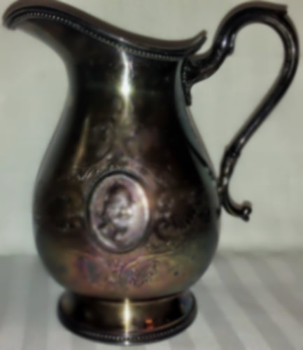 This is an image of a silver plated pitcher.